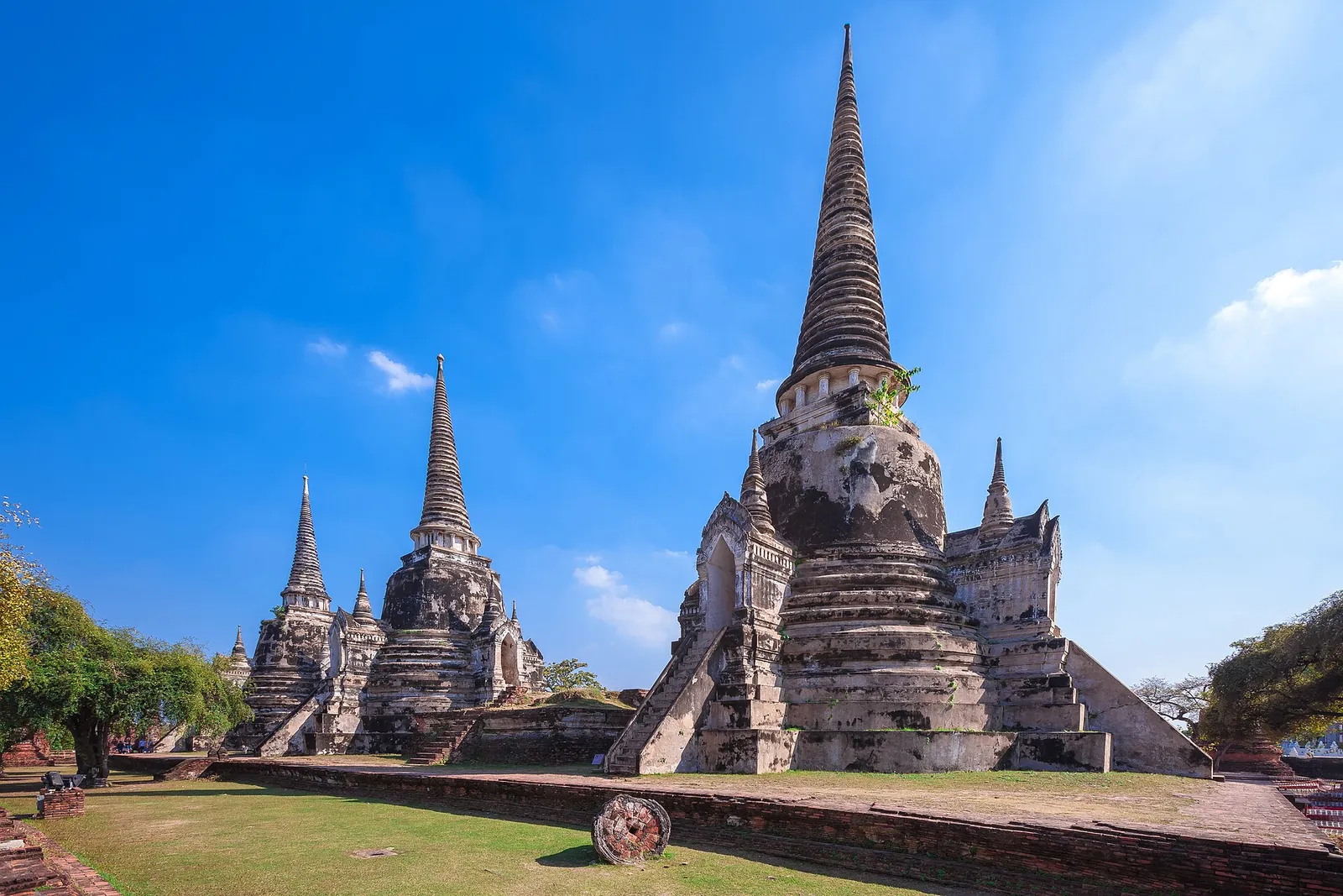 A tall brick prang tower among ruins at Ayutthaya, Thailand