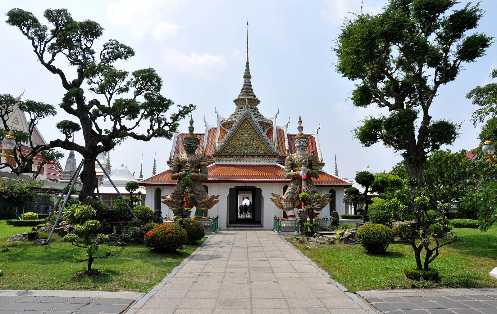 The porcelain-decorated spire of Wat Arun rising above the river in Bangkok, Thailand