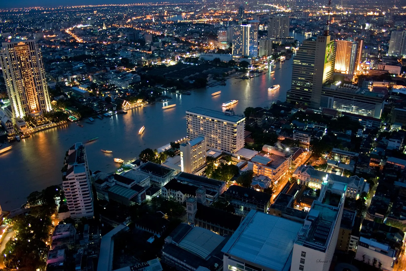 High-rise towers of the Bangkok skyline above the Chao Phraya river in Thailand