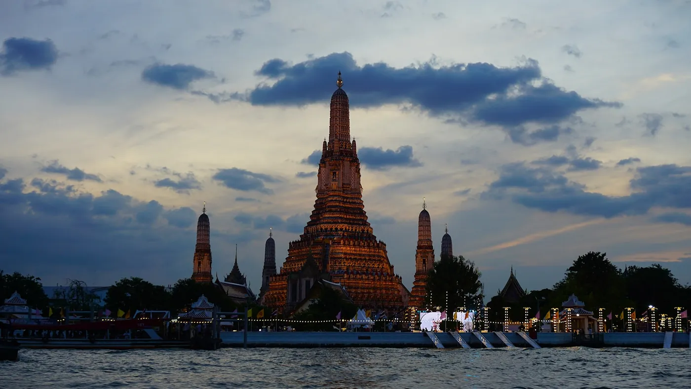 The Temple of Dawn seen across the Chao Phraya river in Bangkok, Thailand