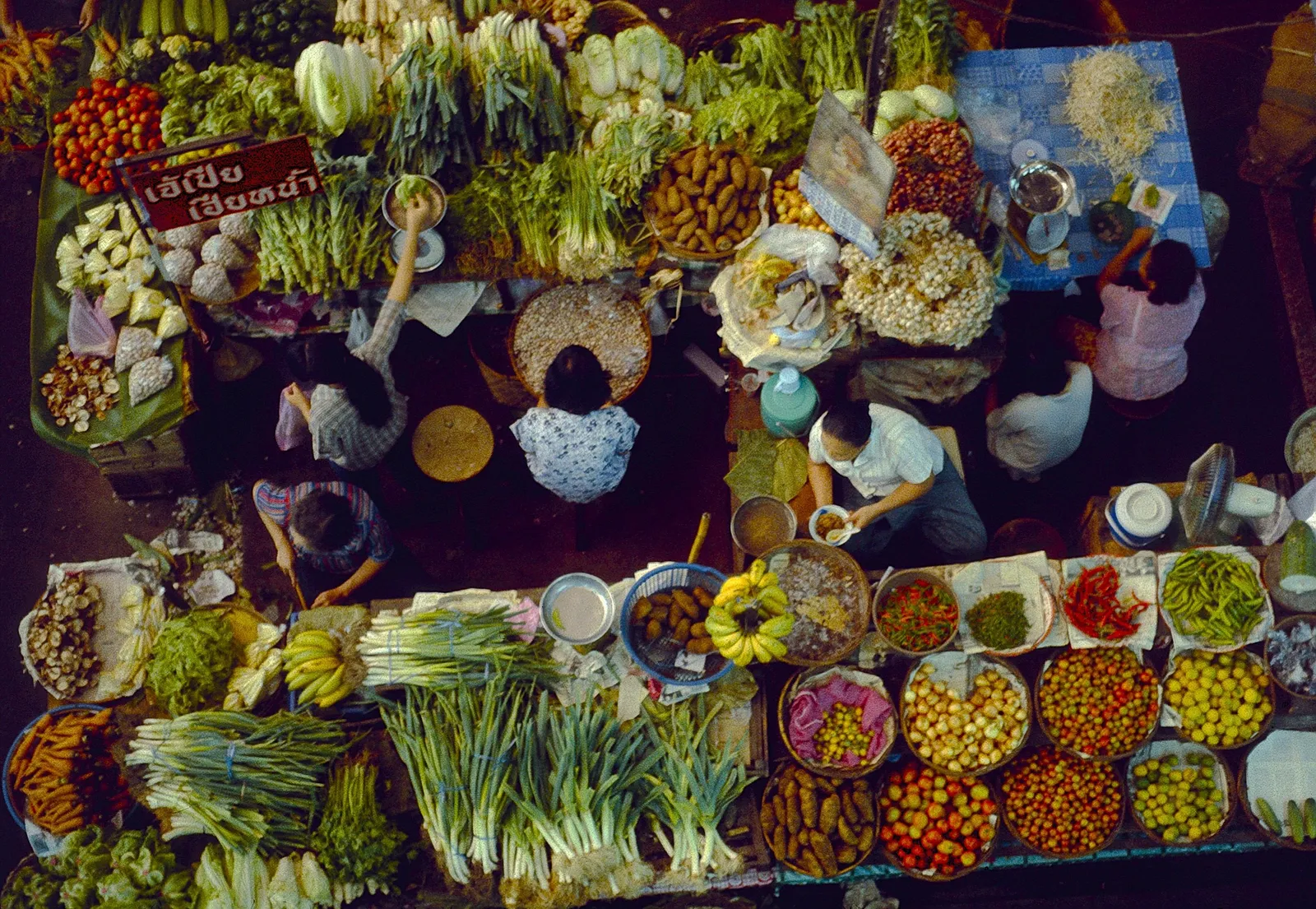 Vegetables, herbs and dried goods laid out across market stalls in Chiang Mai, Thailand, seen from above