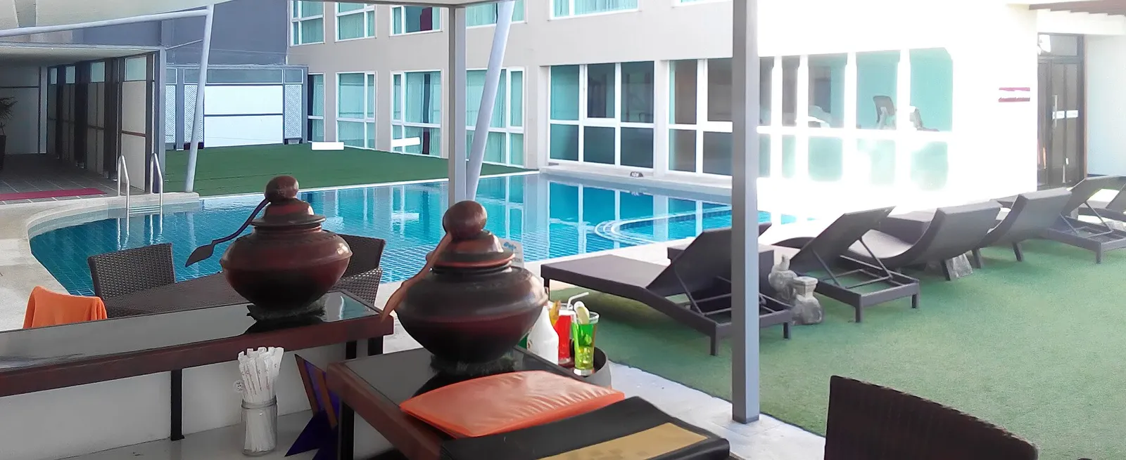 A hotel pool with loungers in Chiang Mai, Thailand