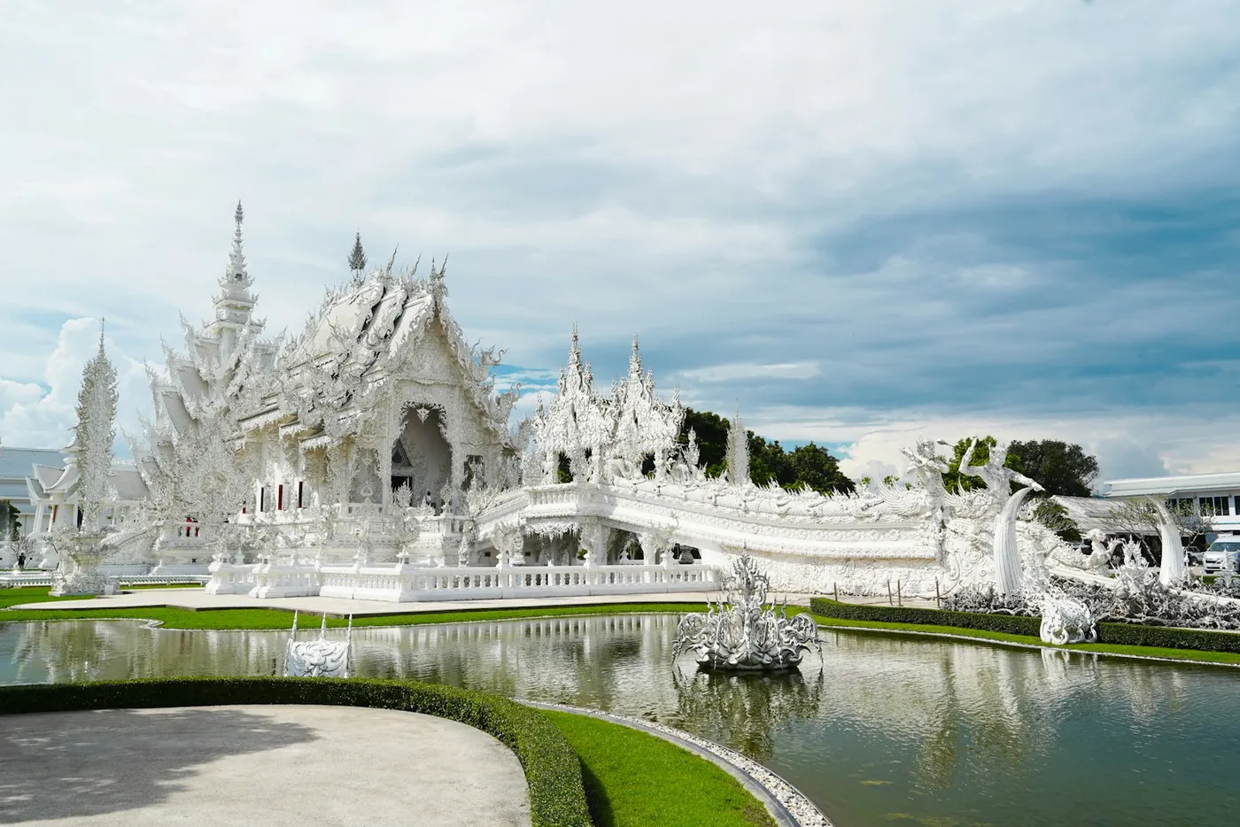 The white spires and bare tree in the grounds of the temple at Chiang Rai, Thailand