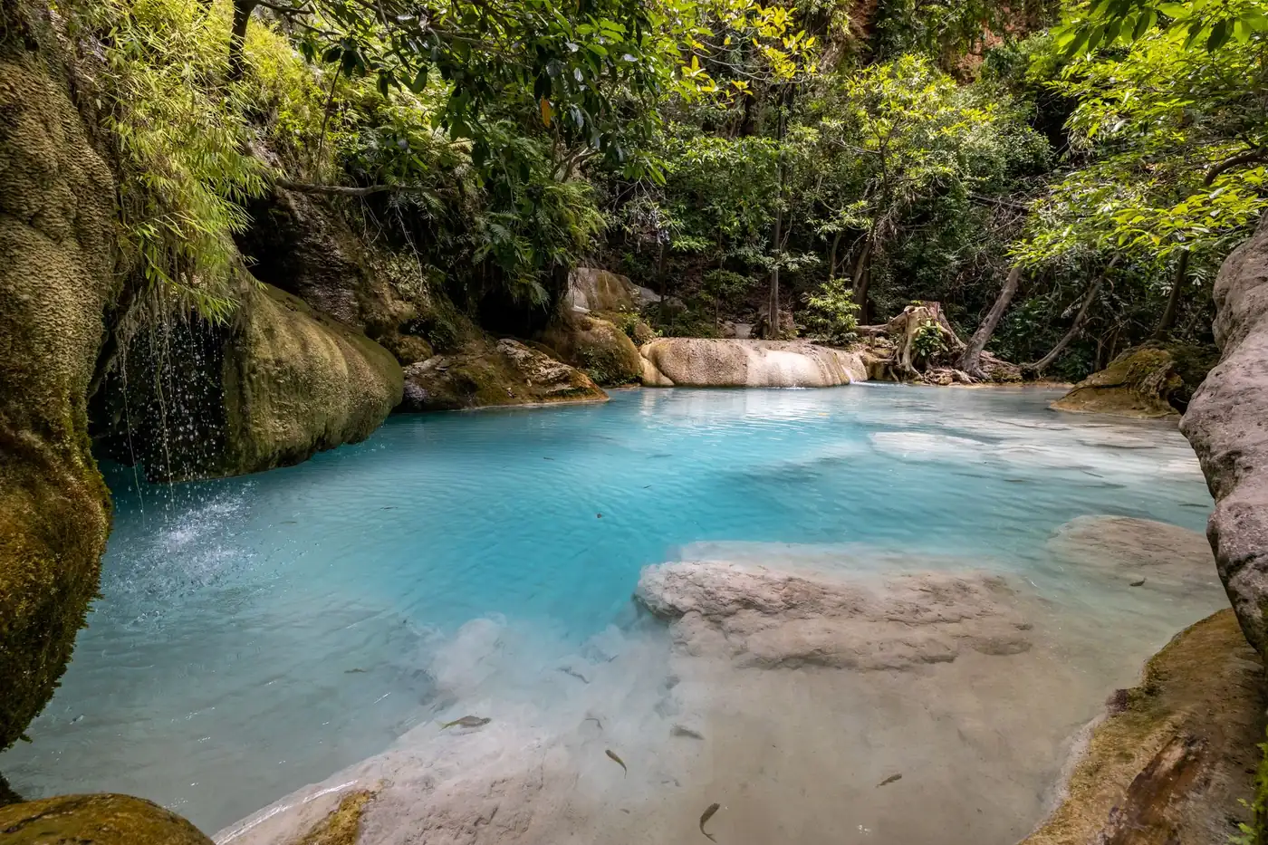 Turquoise pools cascading between forest at Erawan waterfall, Thailand