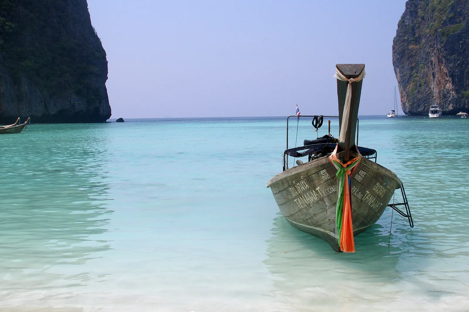 A longtail boat moored in shallow water off a Thai island