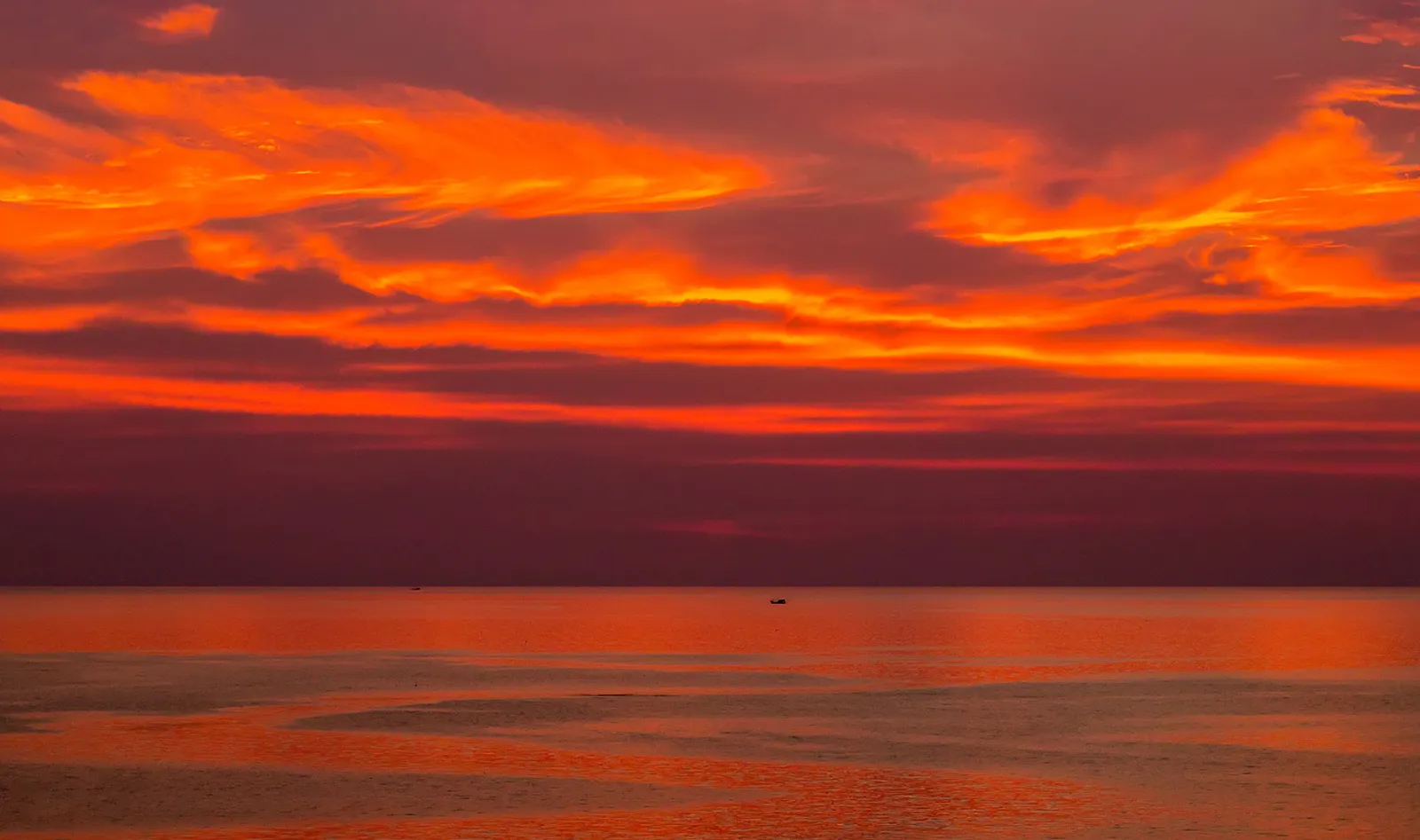 The sun setting over the sea from a beach on Koh Lanta, Thailand
