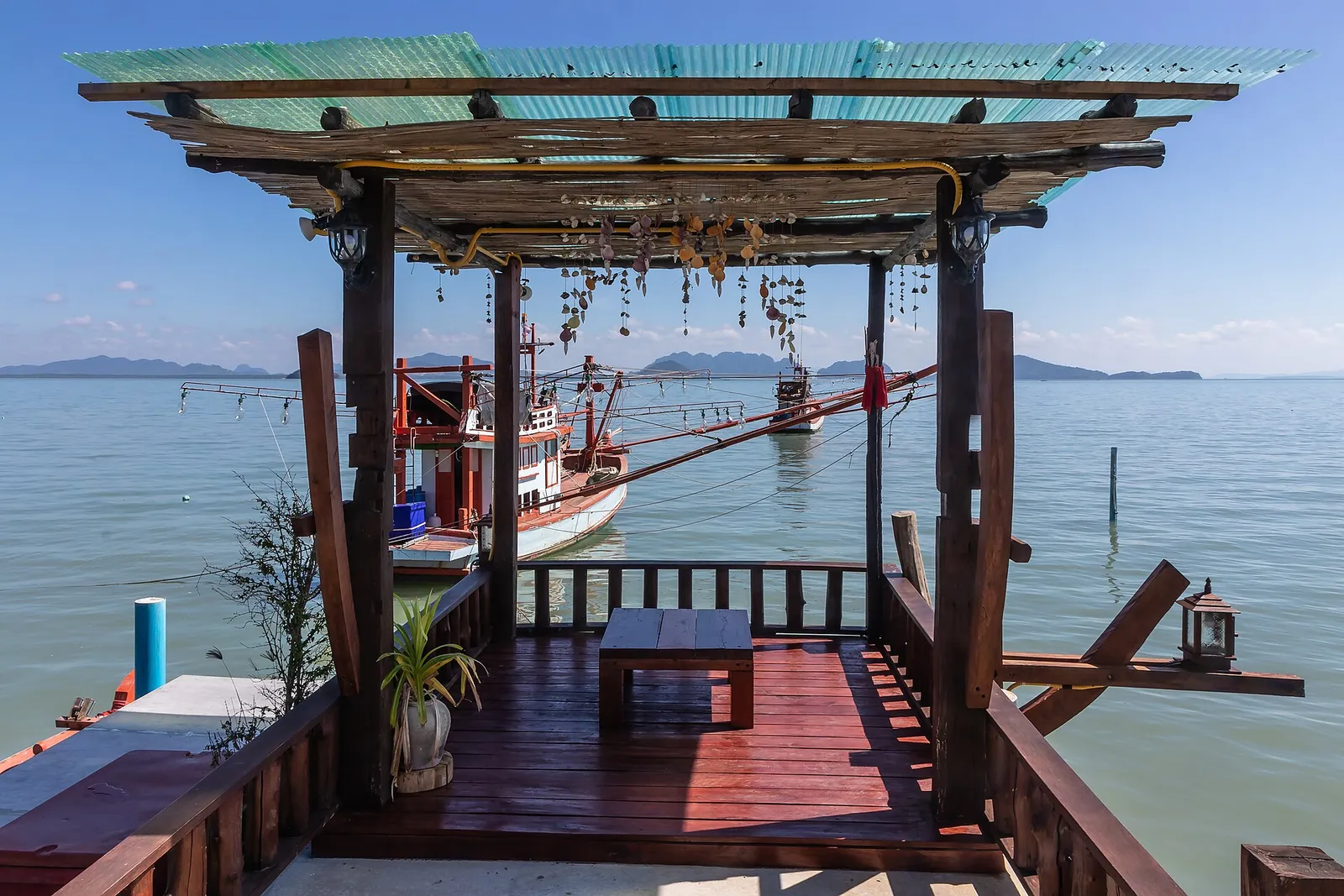 A wooden deck and jetty looking out over the water on Koh Lanta, Thailand