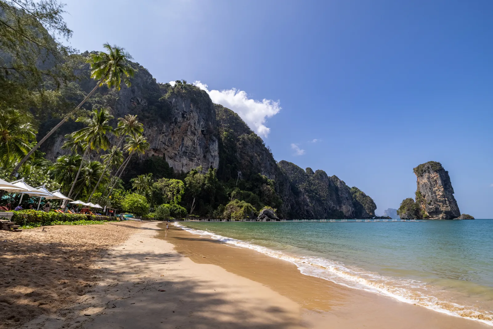 A quiet resort beach with loungers and islands visible offshore north of Ao Nang, Krabi, Thailand