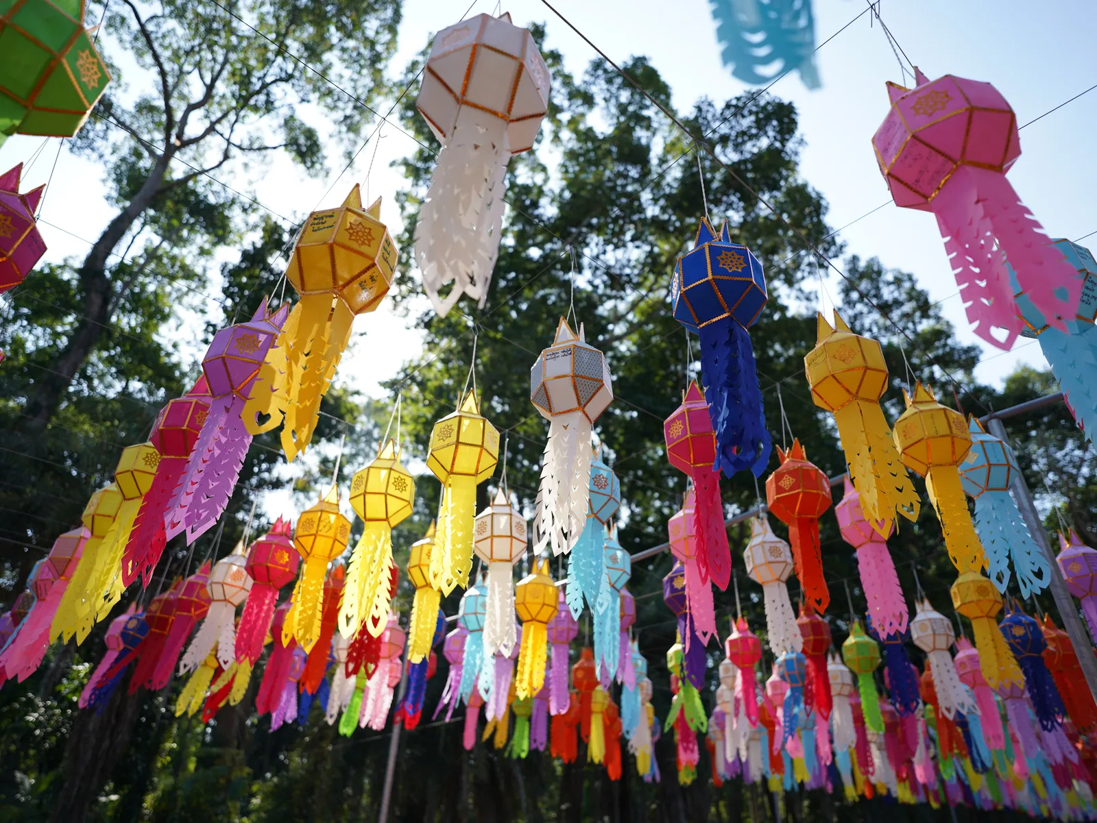 Decorated Lanna paper lanterns hanging in rows at a temple in Chiang Mai, Thailand