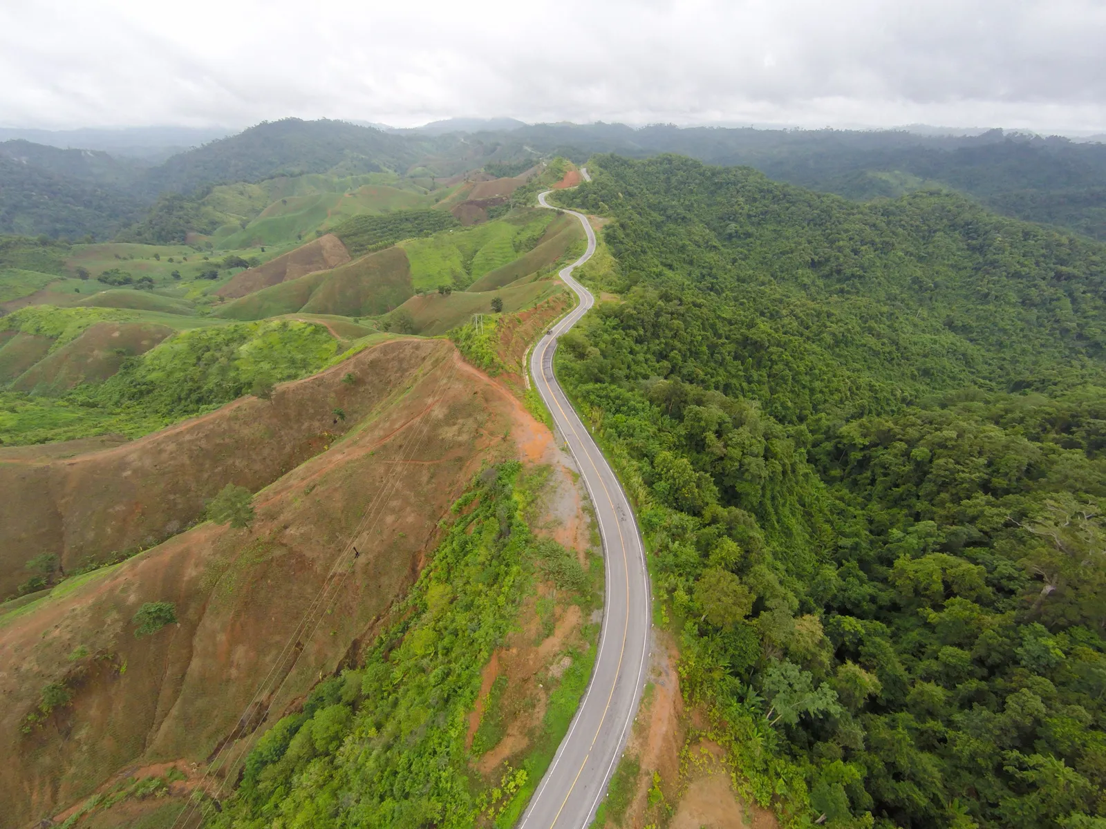 The winding mountain road to Pai in northern Thailand curving through forested hills