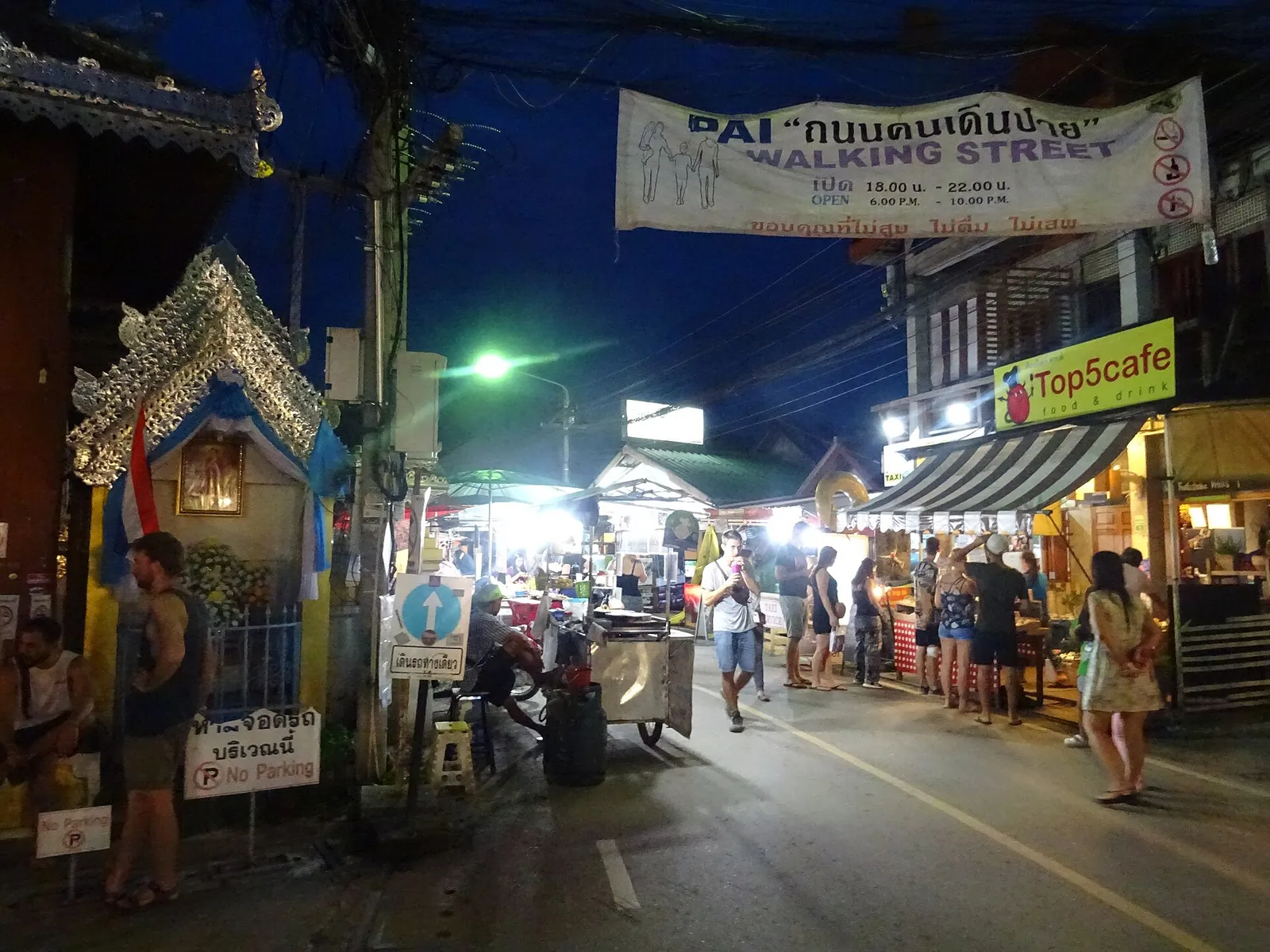 The walking street of Pai lit up in the evening with stalls and visitors, Thailand