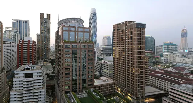 A high view over dense residential and office towers at dusk