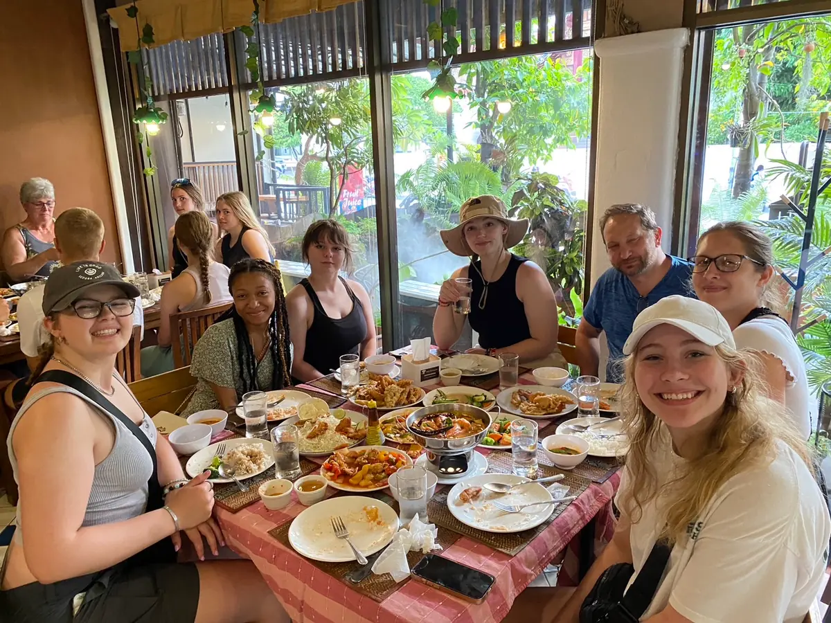 Diners around a table laid with dishes at Thaan Aoan in Chiang Mai