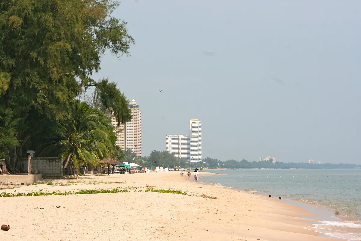 The sand at North Cha-Am, beachfront buildings behind