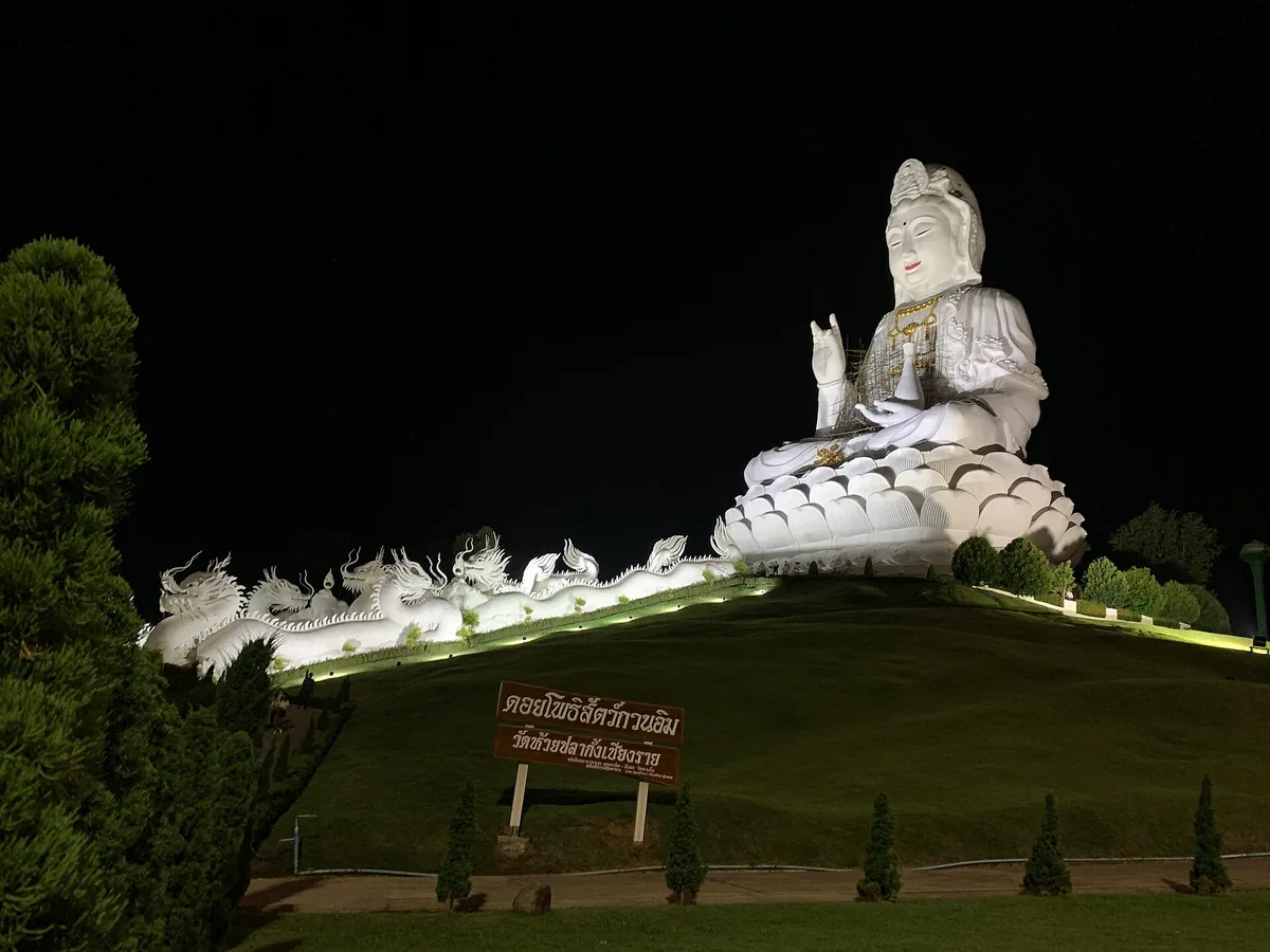 The white Guanyin statue at Wat Huay Pla Kang lit at night