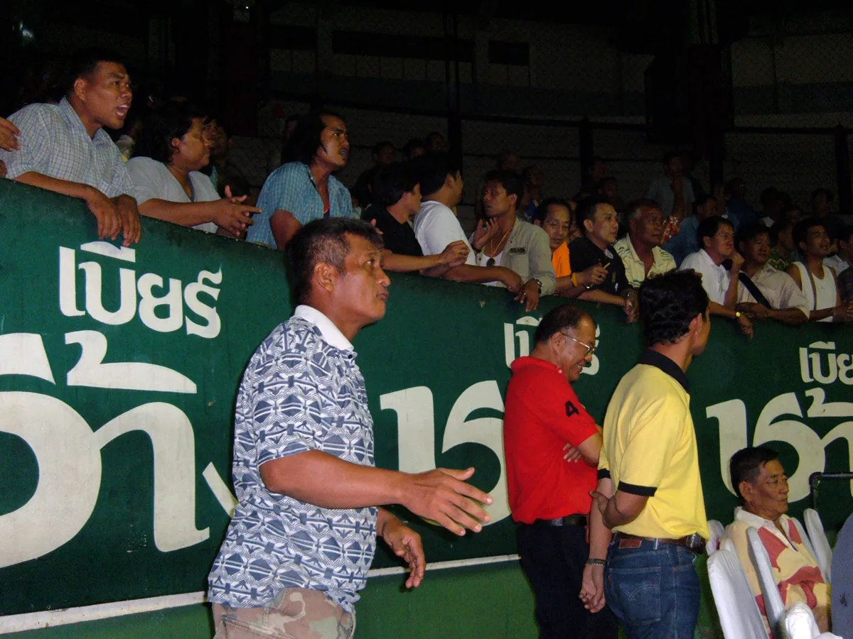 A crowd watching a Muay Thai bout at Rajadamnern stadium