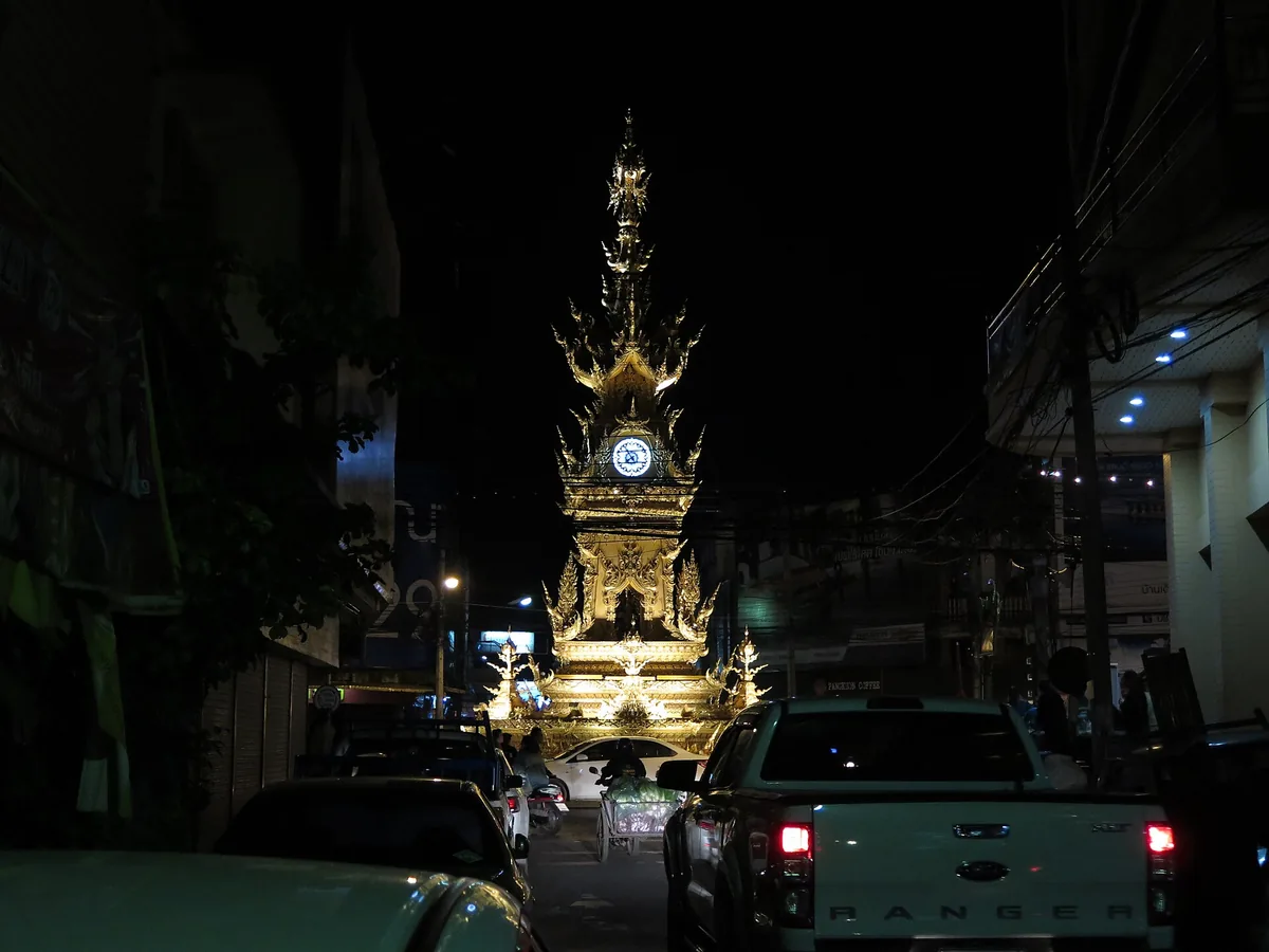 The gilded clock tower of Chiang Rai lit at night