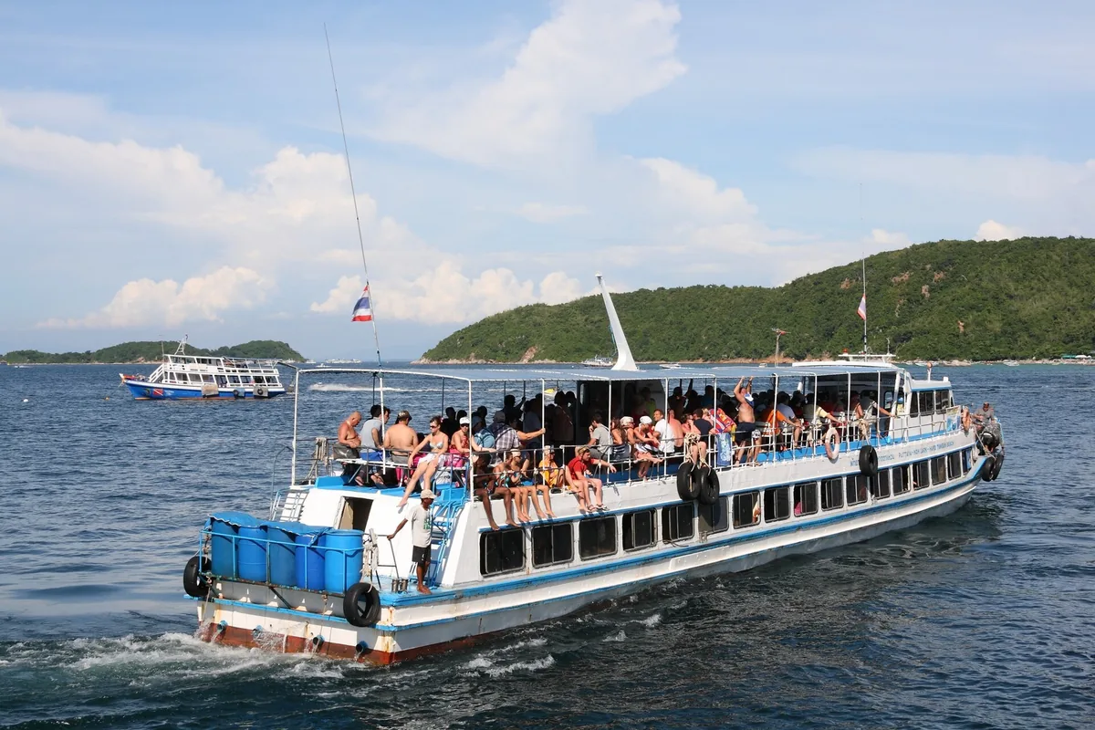 A passenger ferry on its way to Koh Larn, the island behind it
