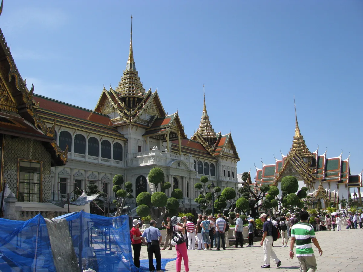 Gilded buildings with steep tiled roofs and pointed spires against a blue sky