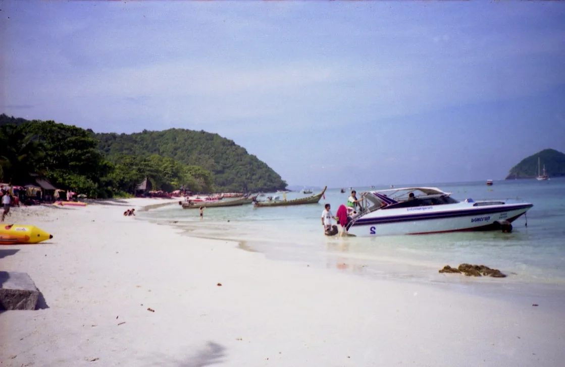 The beach on Coral Island off Phuket, speedboats moored offshore