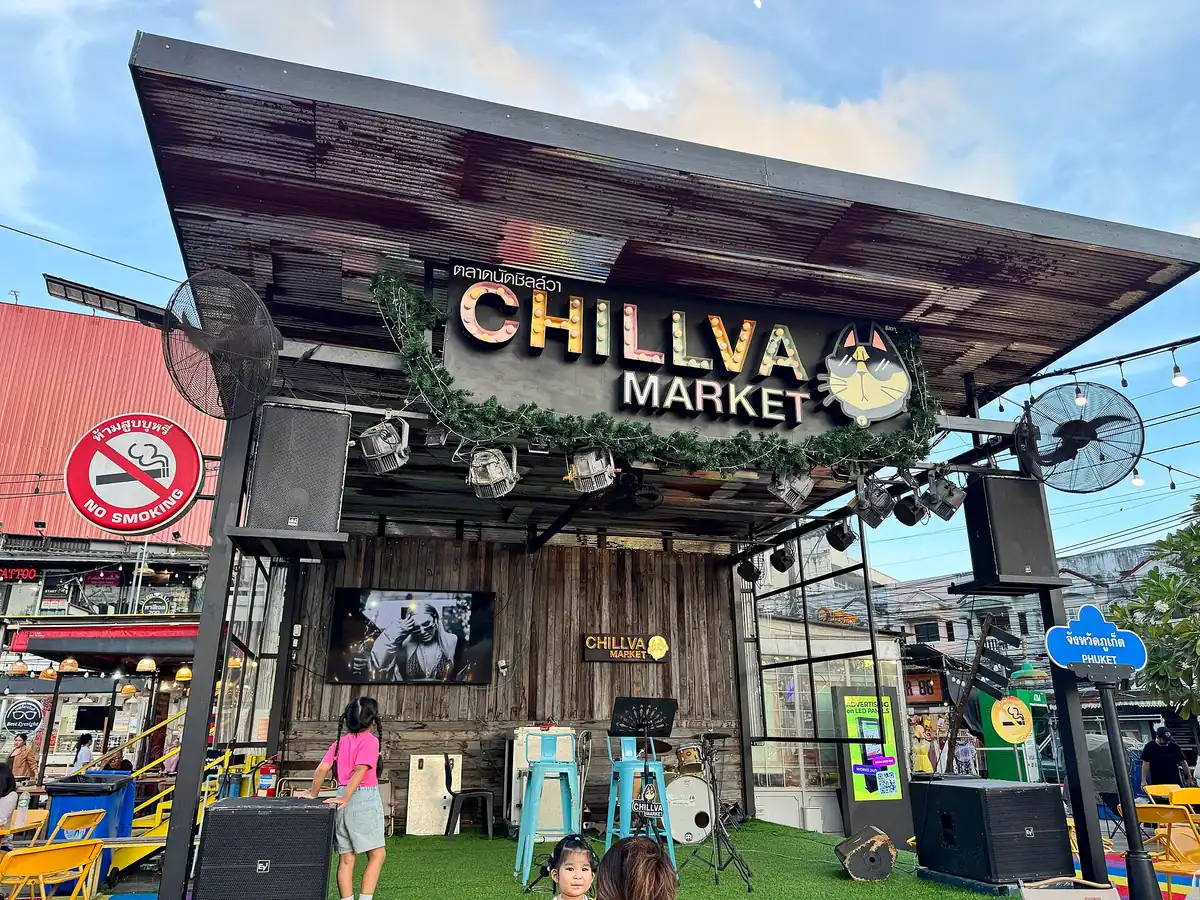 Stalls and a stage at Chillva market in Phuket, the market sign above
