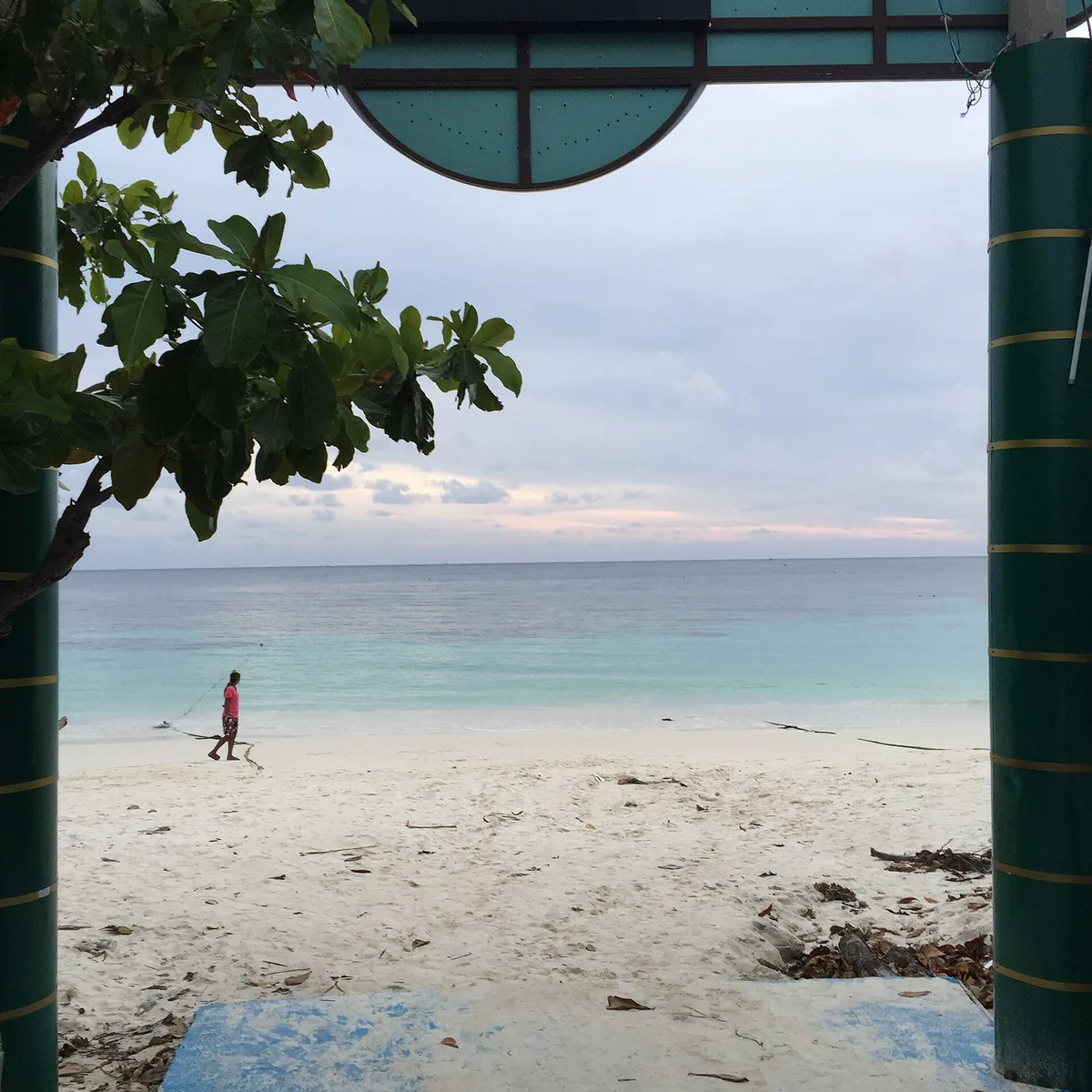 Pattaya beach on Koh Lipe, turquoise water and a lone figure on the sand