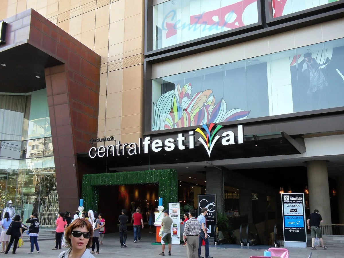 Main entrance of a shopping centre with large signage and shoppers going in