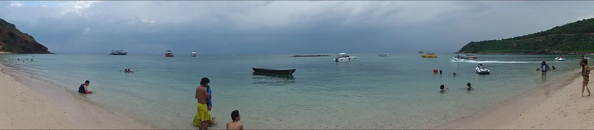 Calm water off Nuan beach on Koh Larn, a boat at anchor