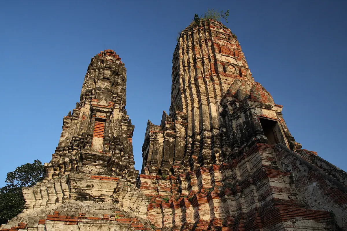 Two ancient brick prangs shot from below against a deep blue sky