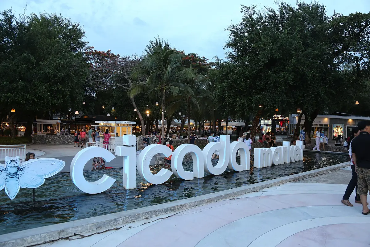 The Cicada market lettering in Hua Hin with visitors around it