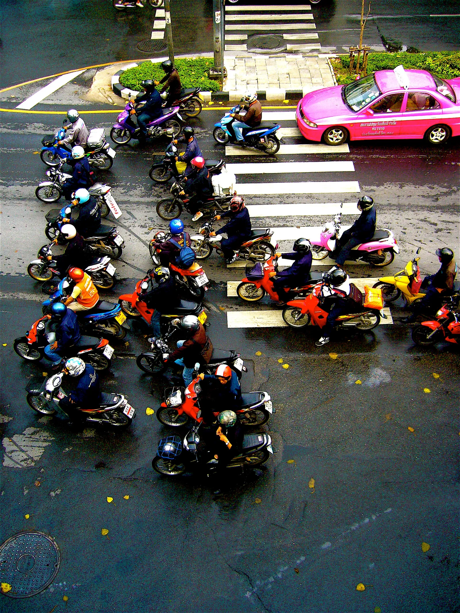 Rows of parked motorbikes on a street in Thailand