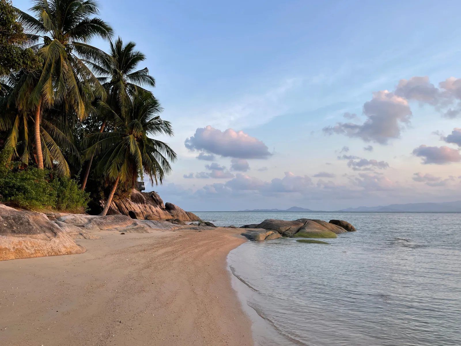 A quiet, facility-free beach on Koh Samui's coast in the late afternoon light