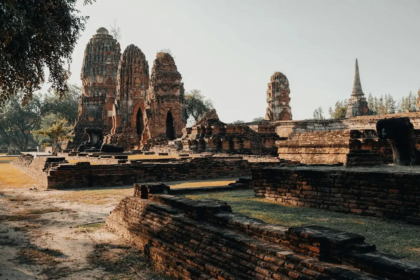 Bicycles parked beside a moat and brick ruins at Sukhothai Historical Park, Thailand