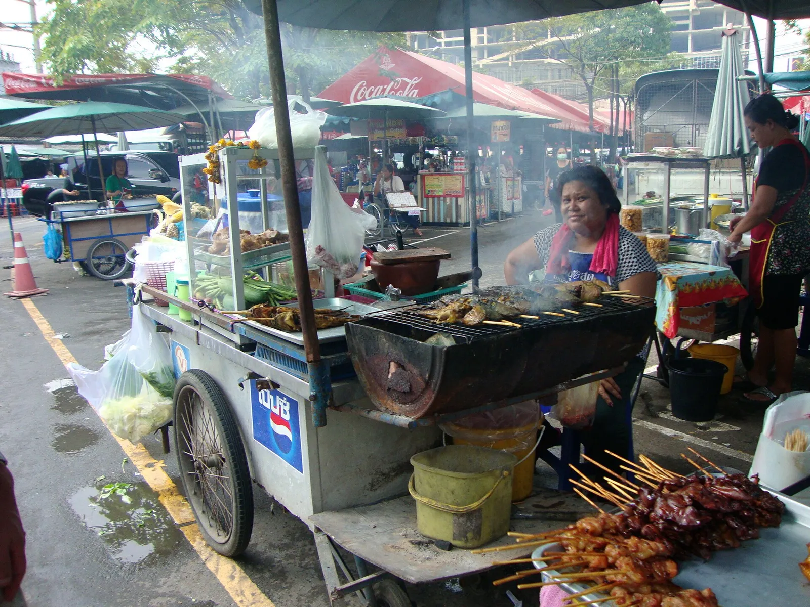 A colourful spread of Thai dishes including curry, pad thai and papaya salad on a wooden table in Thailand