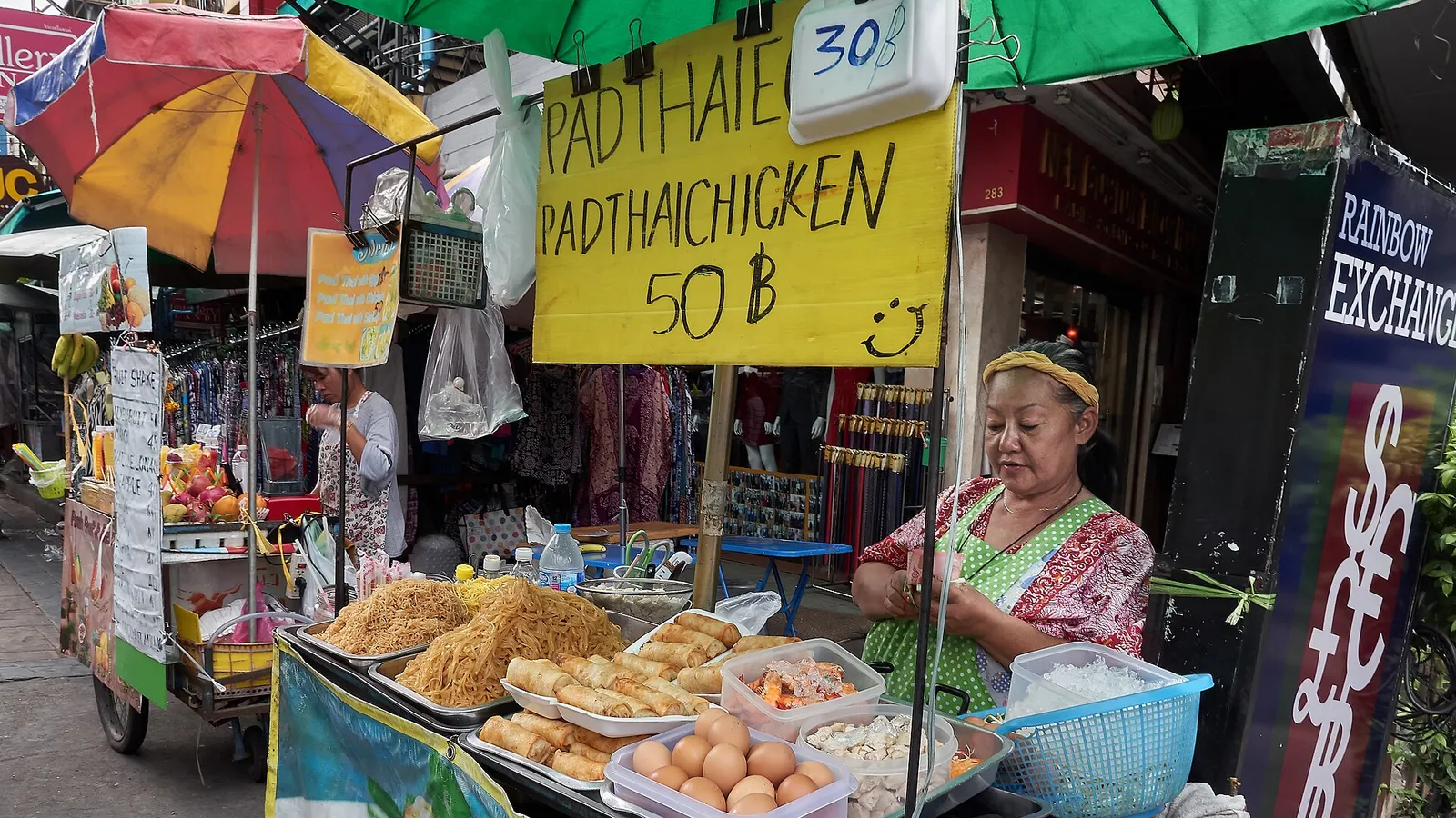 A steaming bowl of khao soi curry noodle soup topped with crispy noodles in northern Thailand