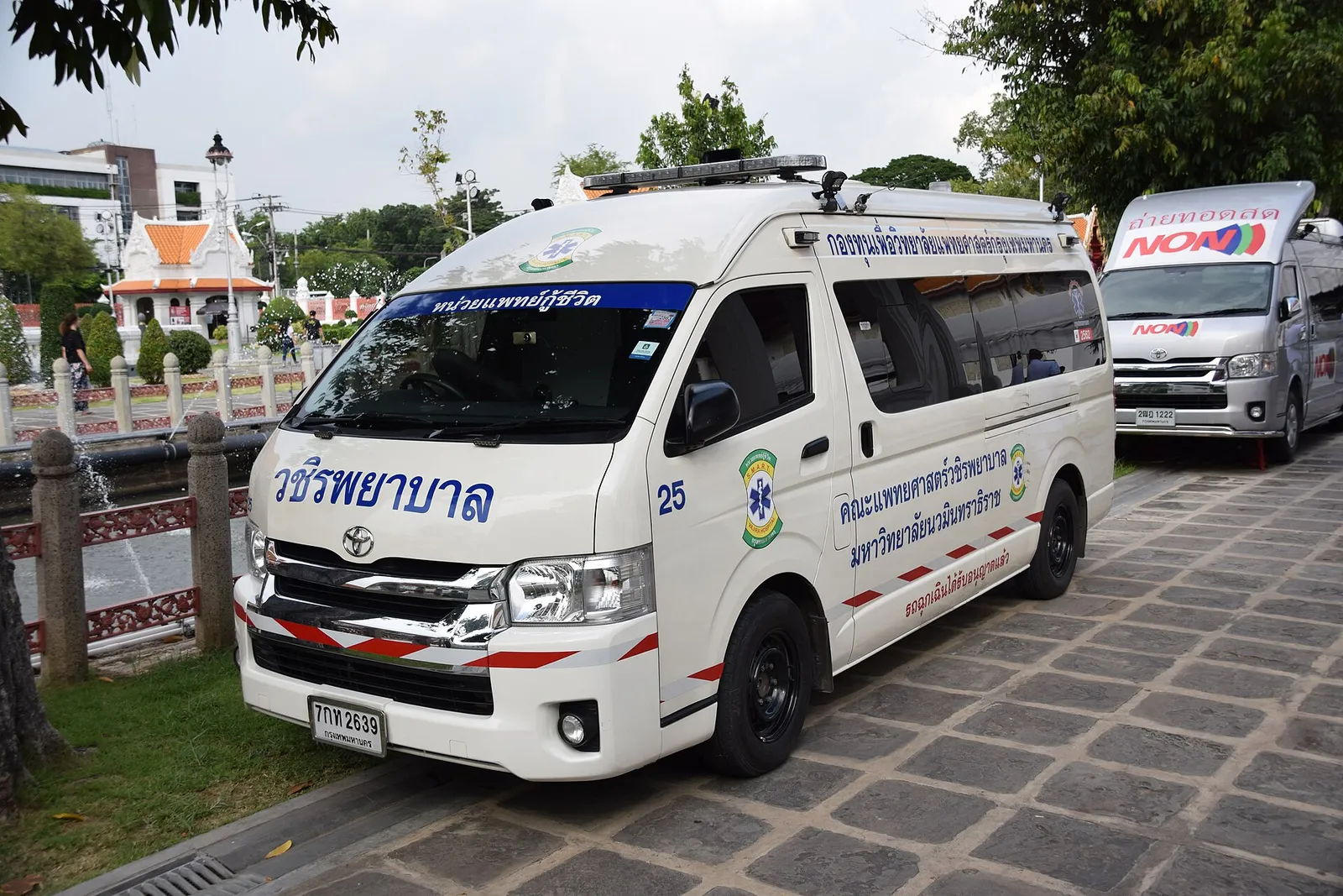 A Thai ambulance parked on a street in Thailand on a bright day