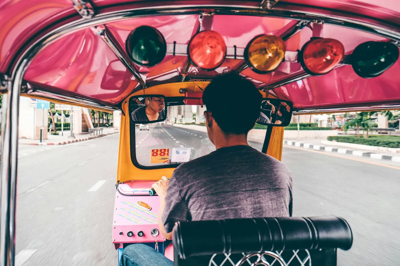 The view from inside a tuk-tuk on a street in Thailand