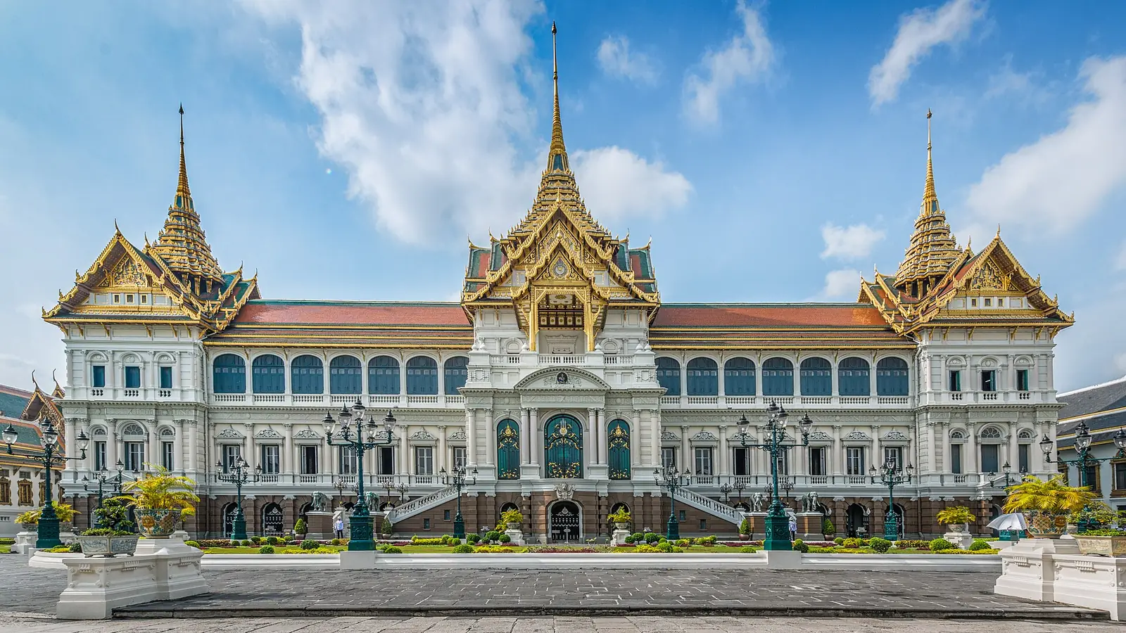 The Grand Palace in Bangkok, Thailand, under a bright blue sky